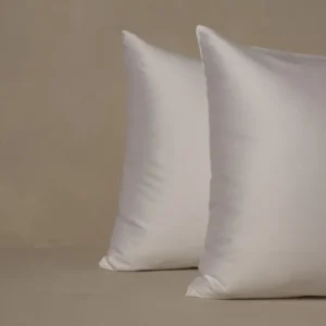 LETTO Giza Reserve Sateen white pillowcase set, two plump pillows on neutral linen surface.