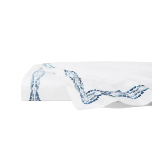 Sferra Cobblestones embroidered white flat sheet with blue oval motif border.