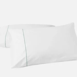 Coyuchi Trailing Embroidered pillowcase pair, white with teal embroidered trim detail.