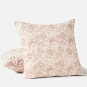 Coyuchi Balboa Matelasse Print pillow in blush floral pattern, two sizes stacked.
