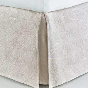 Peacock Alley Vienna ivory matelassé tailored bed skirt with scrolling leaf pattern.
