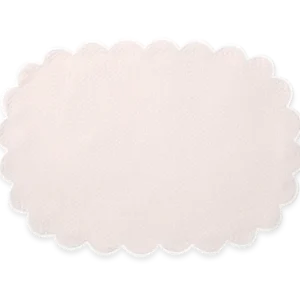 The Matouk Savannah Gardens | Placemat Set features oval-shaped, light beige placemats with scalloped edges, crafted from elegant diamond pique, shown on a plain white background.