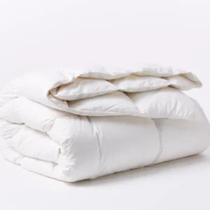 Coyuchi Winter Weight Down duvet insert, white, neatly folded showing plush loft.